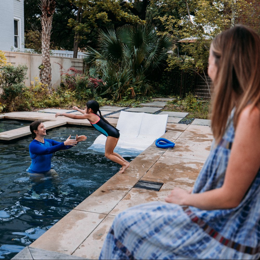 kids jumping into a pool